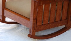 Detail side of Morris rocker showing the hand selected quartersawn white oak in the vertical slats, the steam bent rockers, double pinned true through tenon of the front seat rail and the smaller pinned tenon of the side rail. 